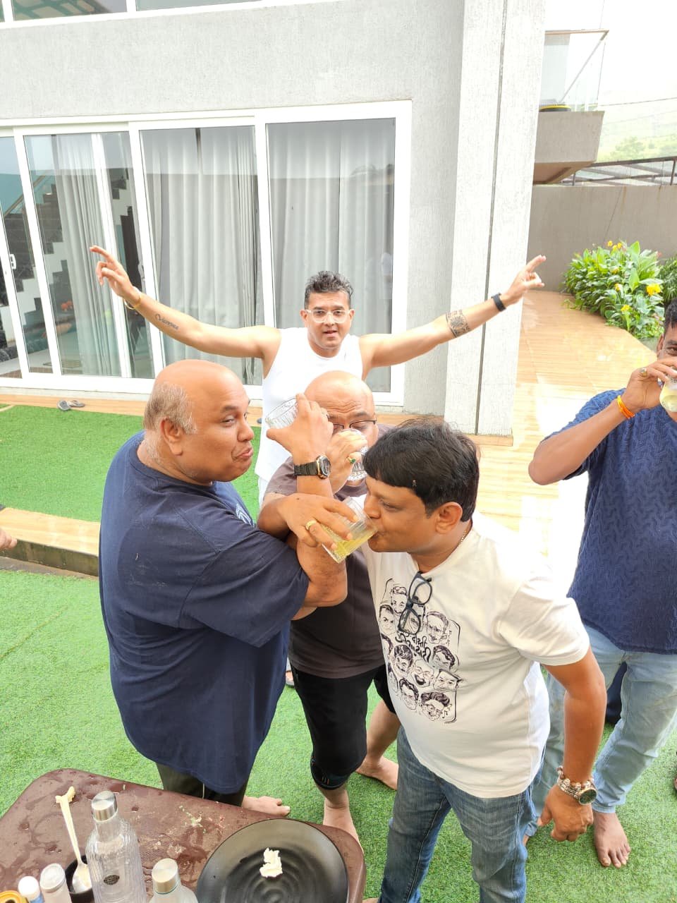 Arms thrown wide in celebration on the lawn