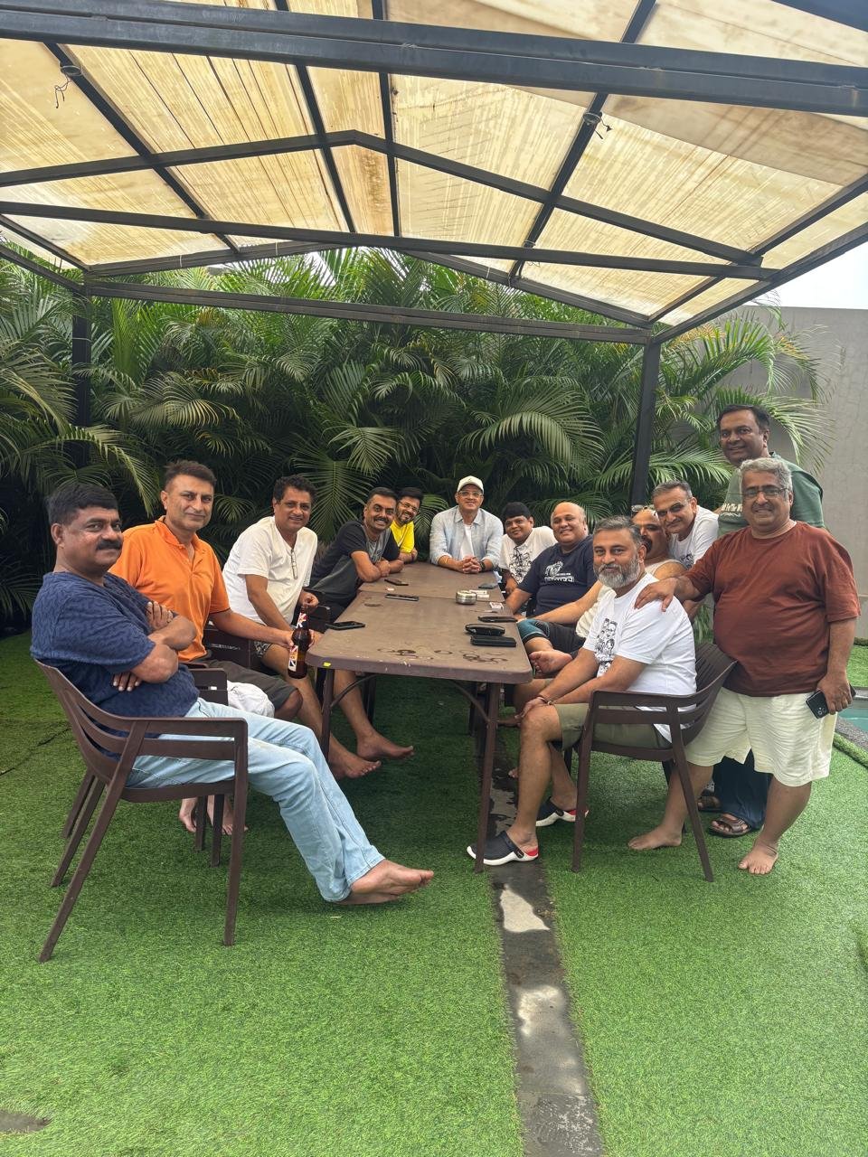 The whole group gathered around the pergola table